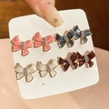 Detail of four pairs of bow-shaped stud earrings in pink, blue, white, and burgundy colors - 4 Pairs Bow Theme Set (HE30738)
