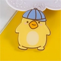 Cute cartoon chick acrylic pin with blue cap and gold trim on yellow background - Duck with Hat