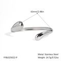 Close-up of wavy stainless steel bangle with polished teardrop ends and 18K gold plating - Silver