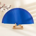 Minimalist blue wooden folding fan displayed elegantly on a traditional wooden stand - Royal Blue