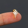 Detailed macro view of a gold kite-shaped zircon stud earring held on a fingertip - Style 5 / Gold