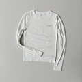 Detail of white long sleeve yoga top featuring thumb holes and high-elastic fabric texture - S / White