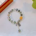 Ethnic green rutilated quartz beaded bracelet with yellow drum beads and lucky charms - Green Ghost: Amazing Success and Bright Future