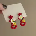 Close-up of red Chinese character ear studs featuring small decorative flowers - 34# Red Chinese 'Xi' Double Happiness (925 Sterling Silver Earring Post)