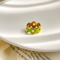Detail of hollow round ring with vibrant green enamel inlay on a golden metal band - US 6 / Green Circle