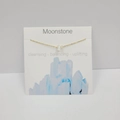 Gold cross chain necklace with natural moonstone pendant on a white display card - Moonstone