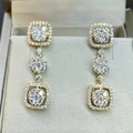 Macro shot of luxury gold bridal drop earrings with sparkling cubic zirconia pave setting - Gold