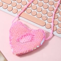 Pink heart-shaped sequin mini coin purse with lanyard on a matching pink keyboard - Brilliant Pink
