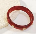 Dark red acrylic bangle with marbled pattern and rhinestone accents in gold base - Red