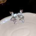 Macro view of butterfly earrings with shell inlay, tassels and brilliant cubic zirconia - Silver (Silver Pin)