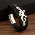 Macro detail of men's black woven leather bracelet with silver lizard charm and magnetic clasp - 21cm / Black + Silver