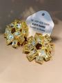 Macro shot of 925 silver vintage geometric hollow earrings with clear zircon crystals - White