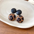 Detail of leopard print and black button earrings displayed on a white ceramic plate - Style 19: Black & Leopard Splicing Double Ball Stud Earrings with Silver Earring Post