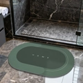 Absorbent green soft diatomite bath mat with white HOME lettering on marble floor - Lake Baikal (oval) - Green (patented Coating)