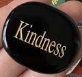 Kindness engraved on a smooth black oval inspirational stone for strength and energy - Obsidian
