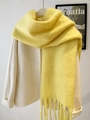 Thick winter mohair yellow scarf with tassels draped on a white coat for extra warmth - Light Yellow