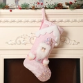 Pink Christmas stocking with sequined Santa Claus hanging on a festive mantelpiece - Pink Santa Christmas Stocking