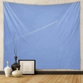 Detail of light blue bohemian tapestry with minimalist airplane trail on a wall - Design CX0327-28