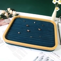 Bamboo jewelry tray with dark blue velvet lining and multiple slots for ring display - Blue