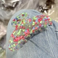 Colorful acetate hair claw clip with multicolor mosaic pattern on blue denim background - Translucent Red Green