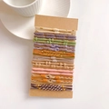 Detail of high-elasticity hair ties on cardboard card with diverse woven textures and colors - Concentric Buckle Style A Set