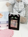 Close-up of a black cat-themed PVC standing photo card binder with cute green eye print - Black Cat