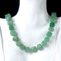 Faceted green natural stone beaded necklace displayed on a mannequin for jewelry styling - Green Aventurine