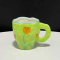 Irregular green ceramic coffee mug with hand-painted orange tulips and wavy handle - Tulip Cup