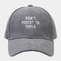 Detail of grey corduroy baseball cap with white embroidered Don't Forget To Smile slogan - Adjustable / Gray