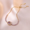 Gold plated titanium bracelet featuring purple zircon floral pendant and adjustable slide clasp - Golden Purple Bracelet / Gold
