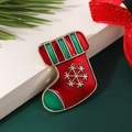 Mini Christmas stocking brooch in red and green enamel with golden snowflake detail - Style 8