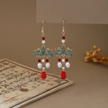 Detail showing enamel cloud patterns and red teardrop pendant on tassel earrings - Red Blue White Gold Cloud Pattern Enamel Drop Style (E6411)