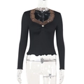 Detail of V-neckline with brown lace trim and small white pearl flower on black top - S / Black