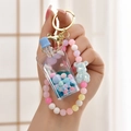 Acrylic liquid sand keychain with blue drifting bottle, colorful beads, and bear charm - Gradient Rope + Colorful Bead Milk Tea Cup / Sucker Cup [Blue]