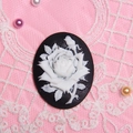 Vintage oval resin rose cameo pendant with white flower on black base over pink lace - Black With White Flowers