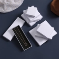 White linen-textured square and rectangular jewelry gift boxes with black sponge inserts - White