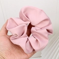 Pink satin large oversized scrunchie hair tie held in hand showing fluffy texture - Pink