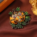Halloween pumpkin brooch with colorful rhinestones and green leaves on dark fabric - Skeleton Pumpkin