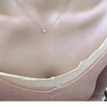 Detailed view of a silver 925 necklace with clear zircon pendant on a model's neck - White Gold