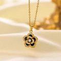 Golden camellia pendant necklace with black enamel petals and shimmering zircon accents - Rose Pendant