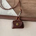 Close-up of retro brown leather pendant case with woven lanyard and metal clasp detail - Brown Mini Envelope Bag (12#)