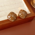 Close-up of square brown earrings with white dots on a wooden display tray - Coffee (Silver Earring Post)