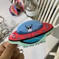 Detail of colorful acrylic UFO hair claw featuring a cartoon alien on a vibrant spacecraft - White Alien (Approx. 10cm)