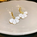 Vintage style white enamel flower earrings with gold center petals in a ceramic dish - Drip Oil Flower Ear Buckle / White