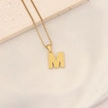 Gold stainless steel necklace featuring a letter M pendant with honeycomb texture finish - M