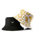 Fashionable reversible bucket hat with smiling face and cow pattern print in black and yellow - Double Sided Smile Cow Print / Yellow White Cow Print