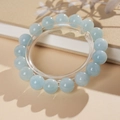 Detail view of light blue beaded bracelet on a display stand with soft botanical shadows - 10mm Specification (With Gift Box)