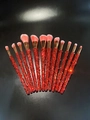 Detail of 12-piece makeup brush set featuring red rhinestones and pink gradient bristles - 12pcs Set / Pink Red Mixed Rhinestones