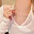 Titanium steel necklace with silver bow pendant featuring zircon inlays on model neck - Ring Floating Main Diamond (X1930) / Silver/Ring Nested