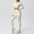 Detail of high-waist yoga leggings with side pockets and cropped long sleeve top set - Light Ivory